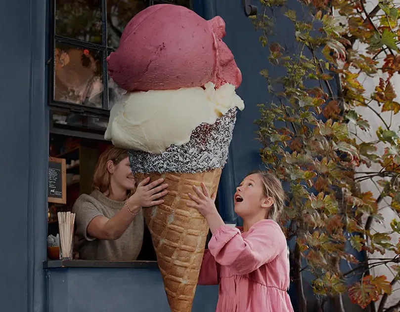 Girl being given a huge ice cream